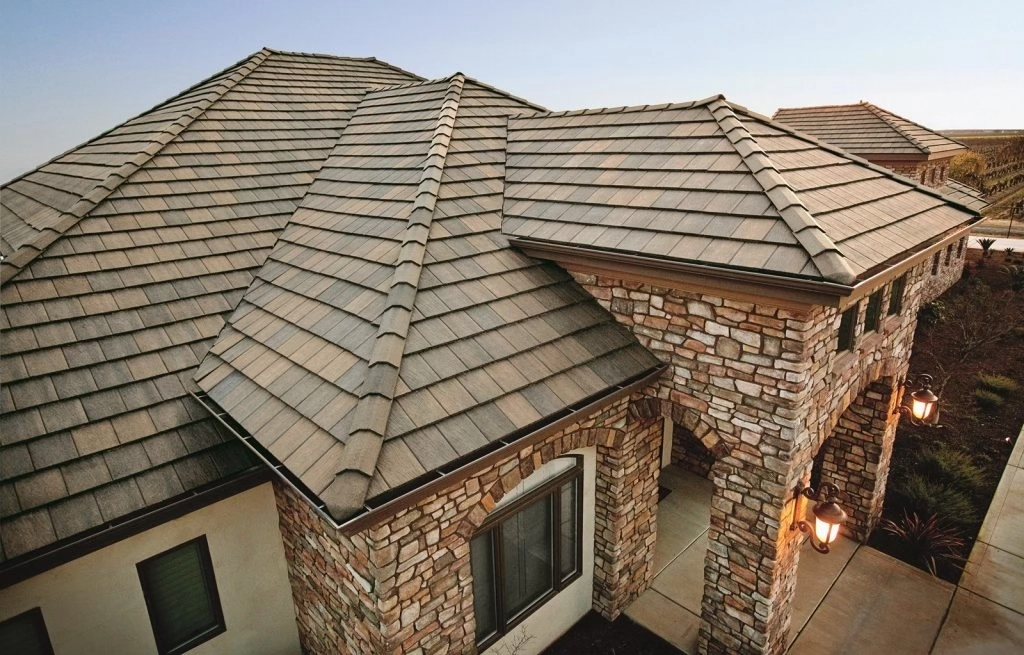 Textured cedar shake style roof complementing a beautiful stone-sided home.