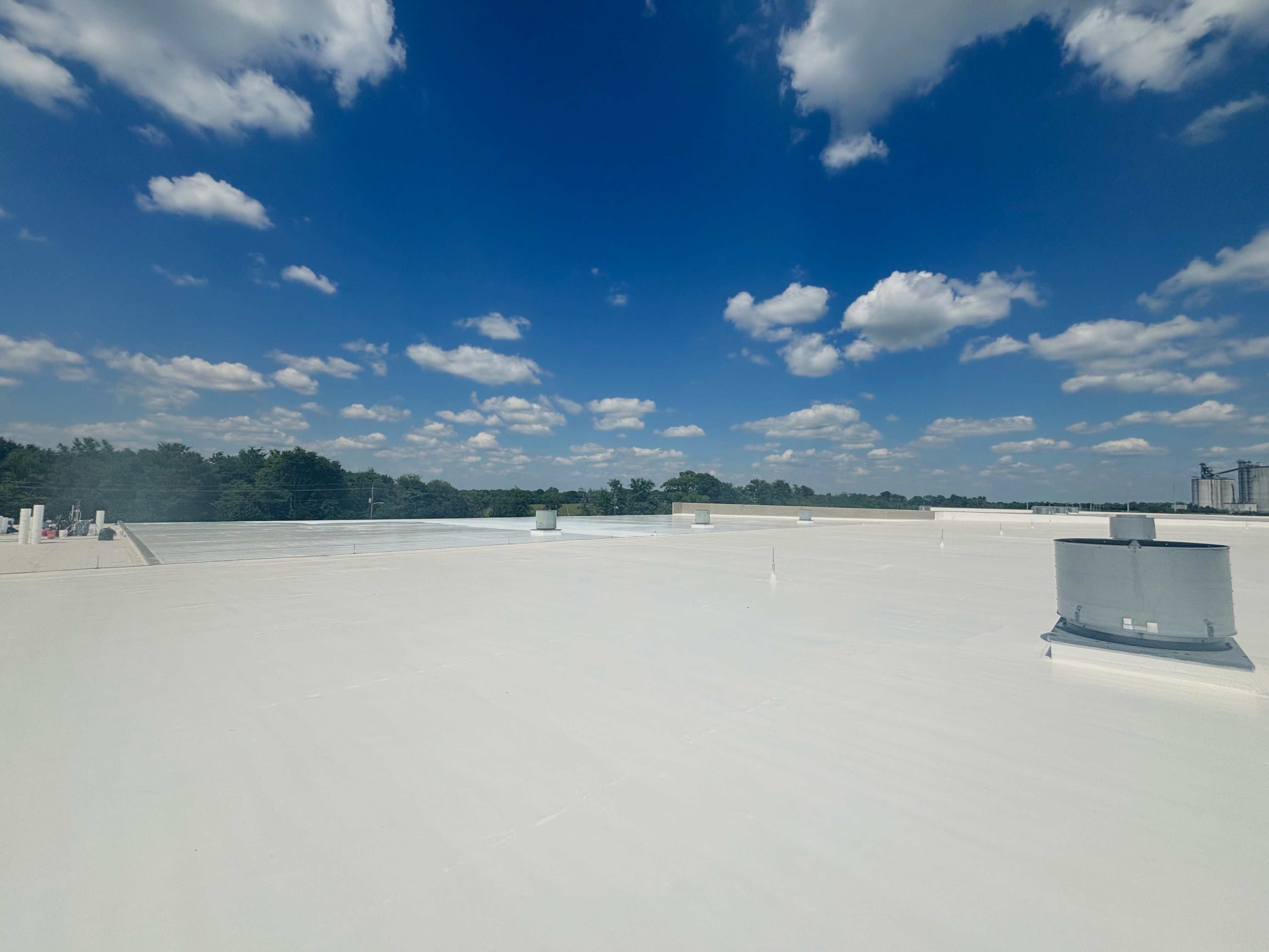 Wide-angle view of a massive white TPO roof, showcasing its clean look and durability.