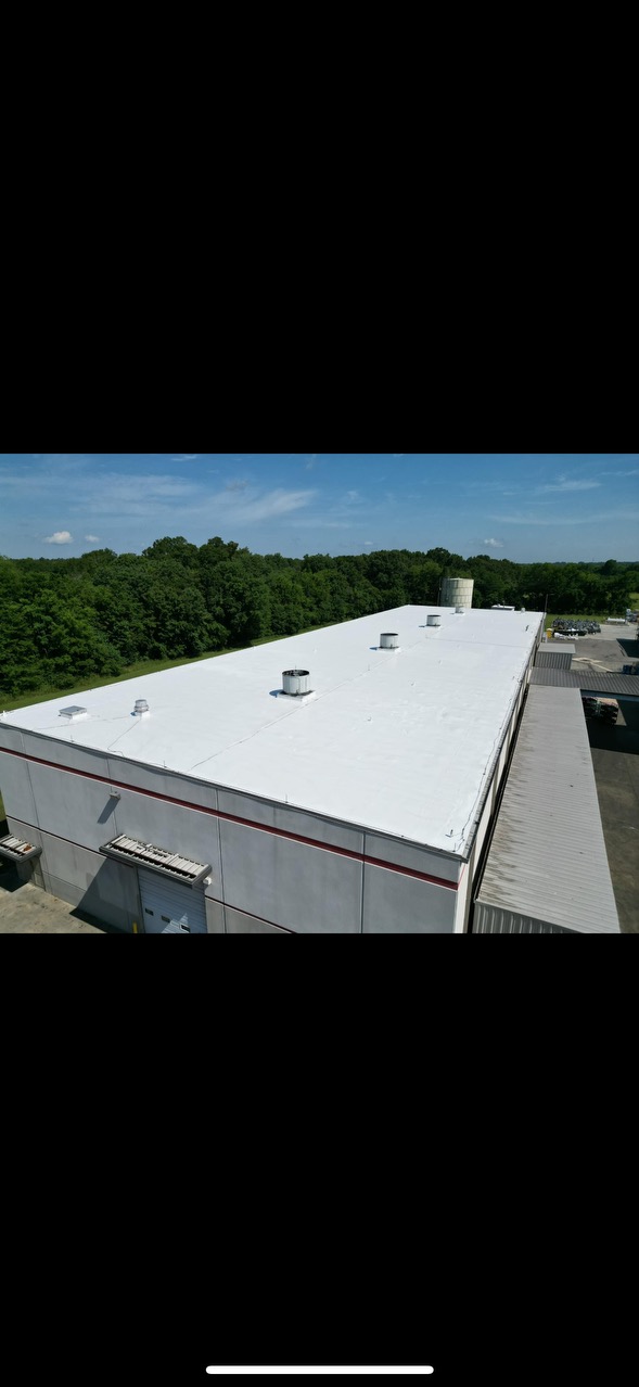Aerial view of a completed TPO roof on a commercial facility with loading docks.