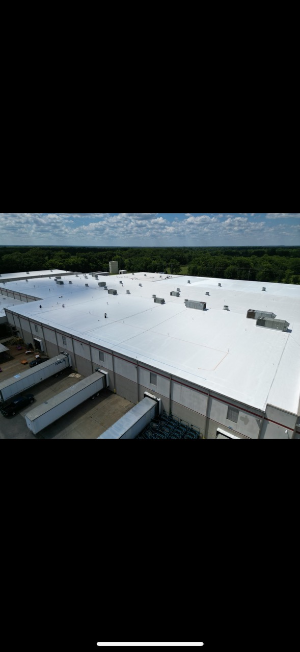 Complete TPO roofing system on a large-scale warehouse with multiple truck bays.