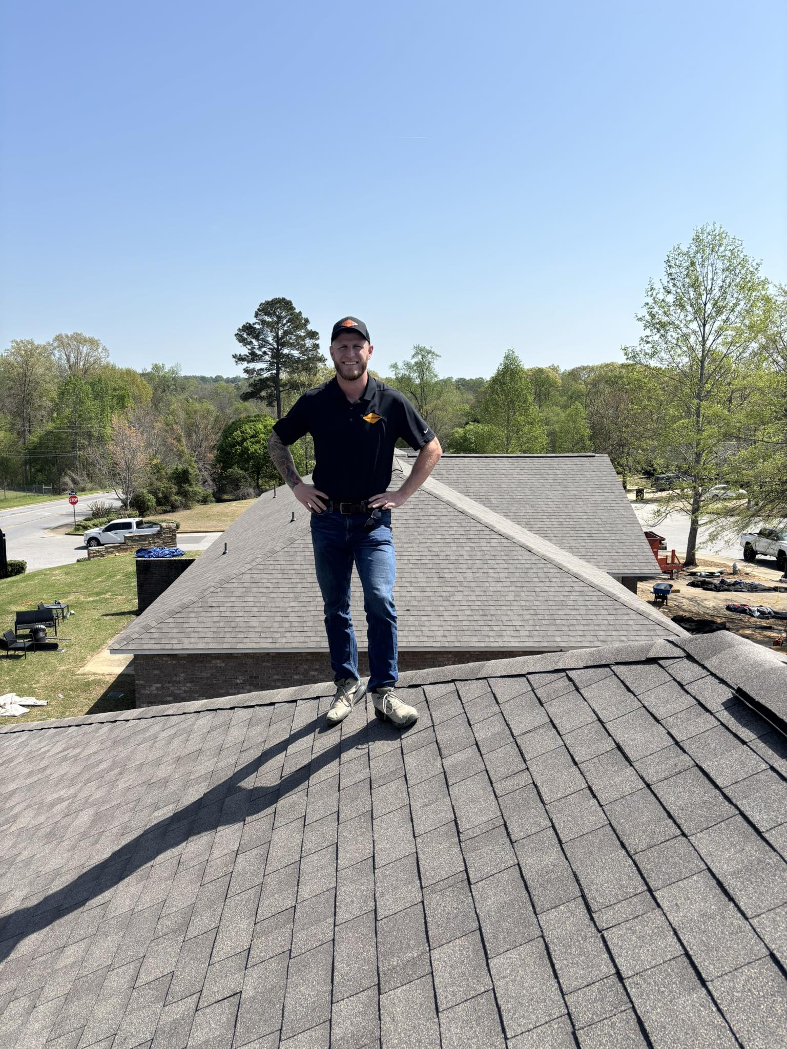 Founder of Summit Roofing Professionals standing on a finished residential roof project