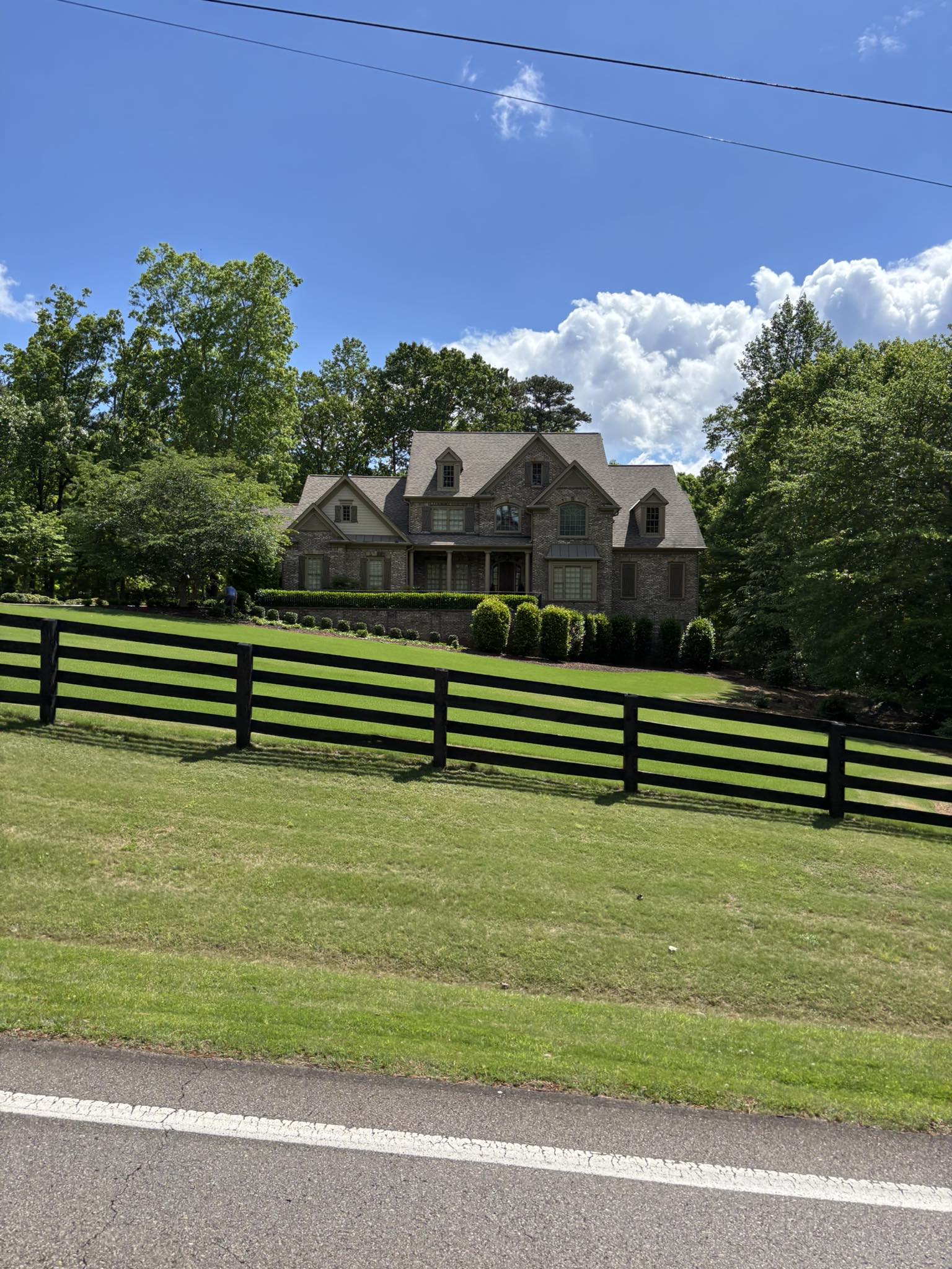 A stunning architectural shingle roof on a grand brick and stone estate in Atlanta.