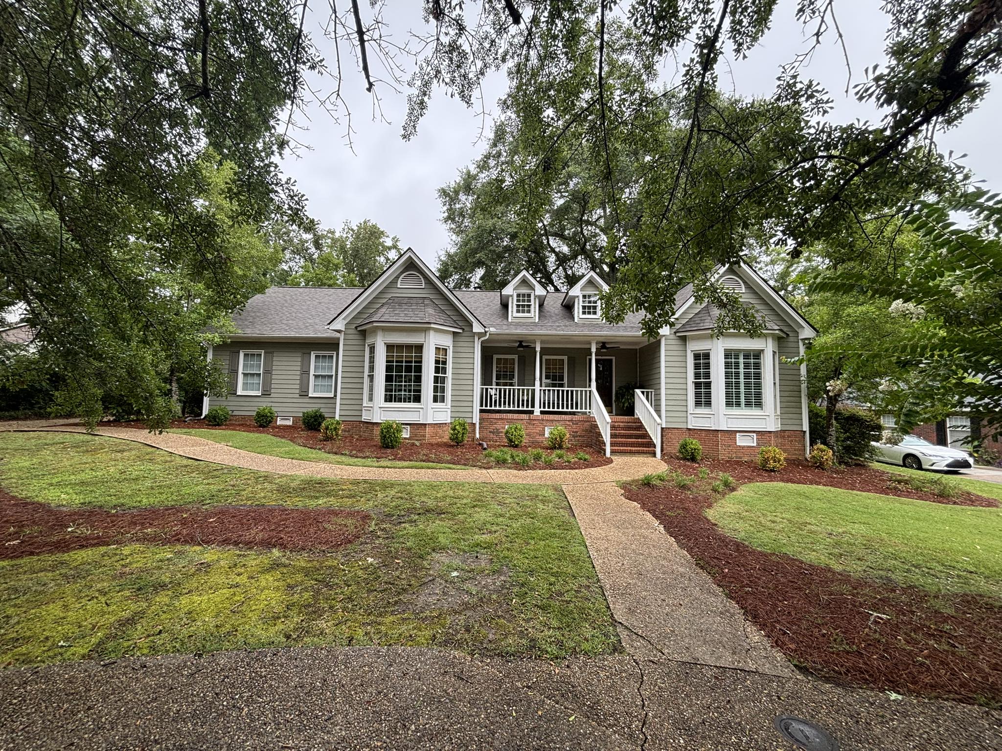A beautiful new shingle roof on a classic home with bay windows in Auburn, AL.