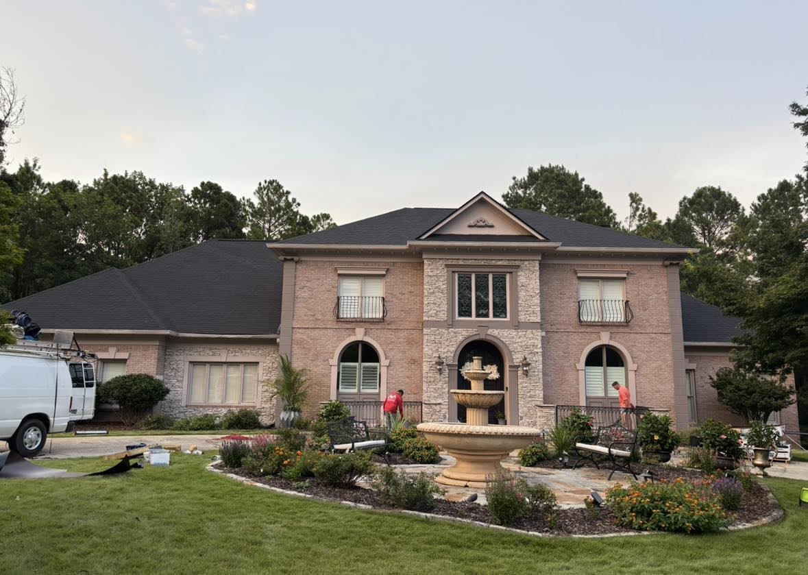 A new roof perfectly complements the beautiful landscaping of this manor-style home.
