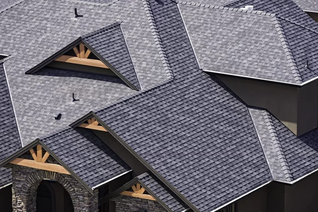 Close-up of expertly installed architectural shingles on a luxury home with complex gables