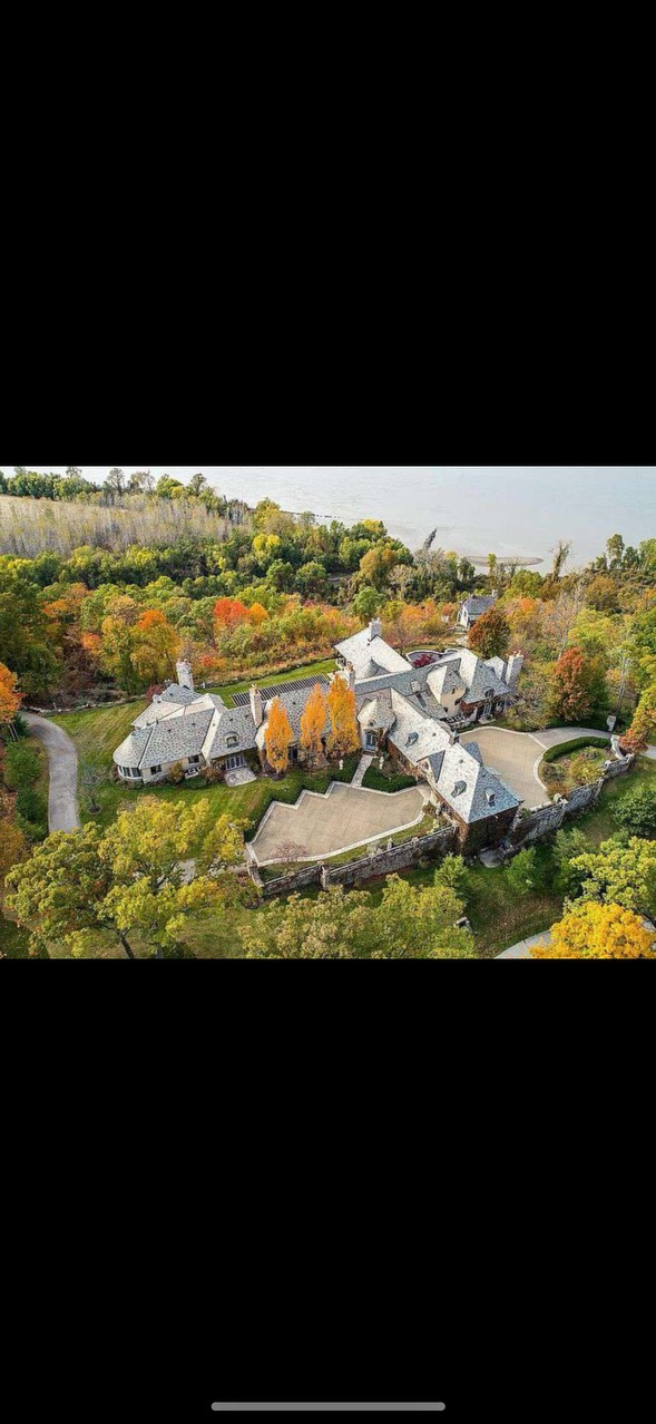 Expansive slate roof on a beautiful estate surrounded by vibrant autumn foliage.