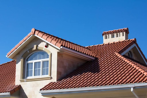 Vibrant red clay tiles providing a timeless look against a bright blue sky.